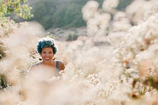 Smiling person in a sunny flower field