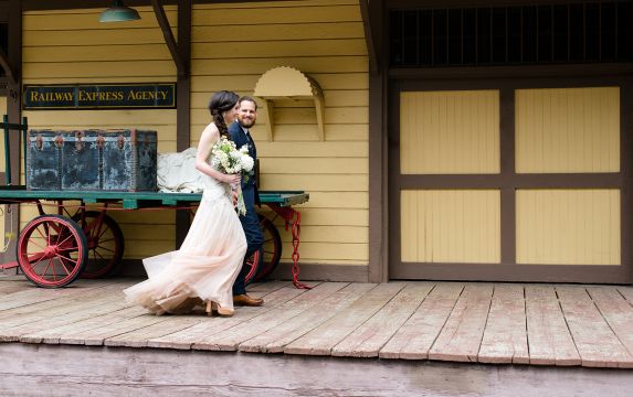 Couple walking by vintage railway station