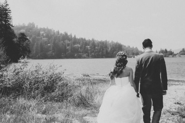 Bride and groom walking by a lakeside