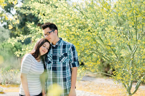 Couple standing together near blooming tree outdoors