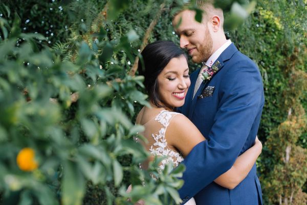 Bride and groom embracing outdoors