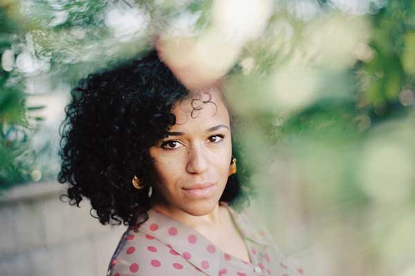 Woman with curly hair posing outdoors
