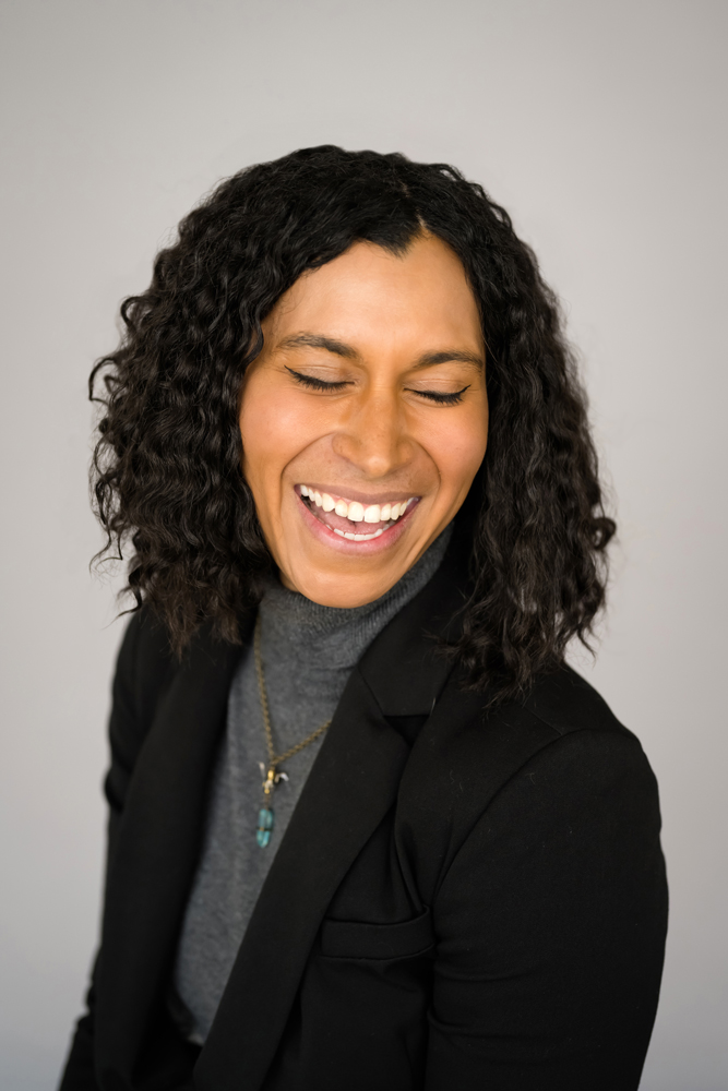 Person smiling with eyes closed in gray background - Pricing - Denver Headshots Photographer