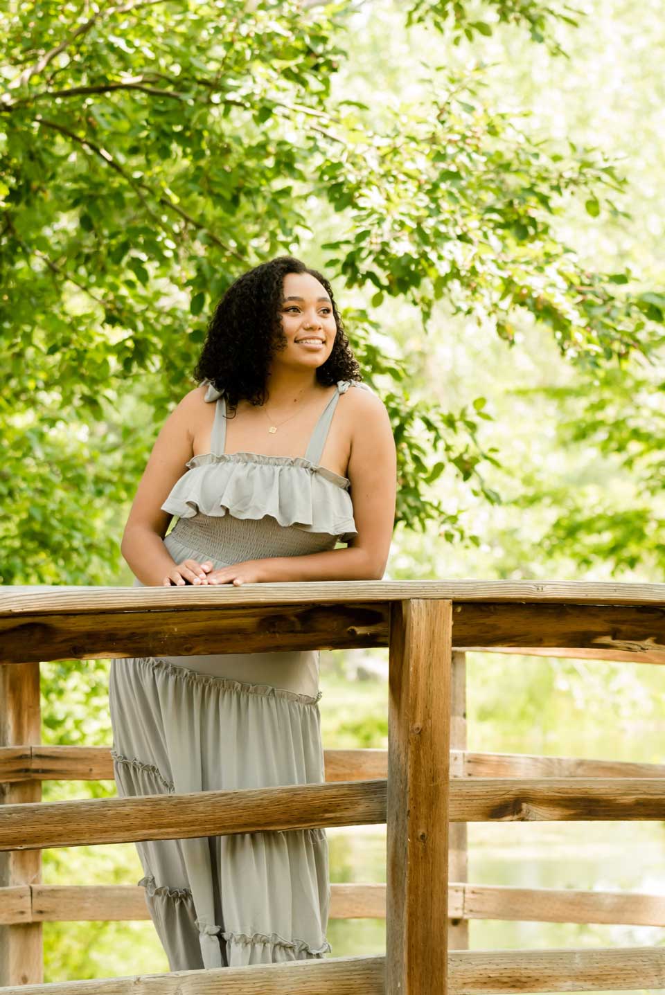 Seniors-Pricing-image Woman in green dress on wooden bridge